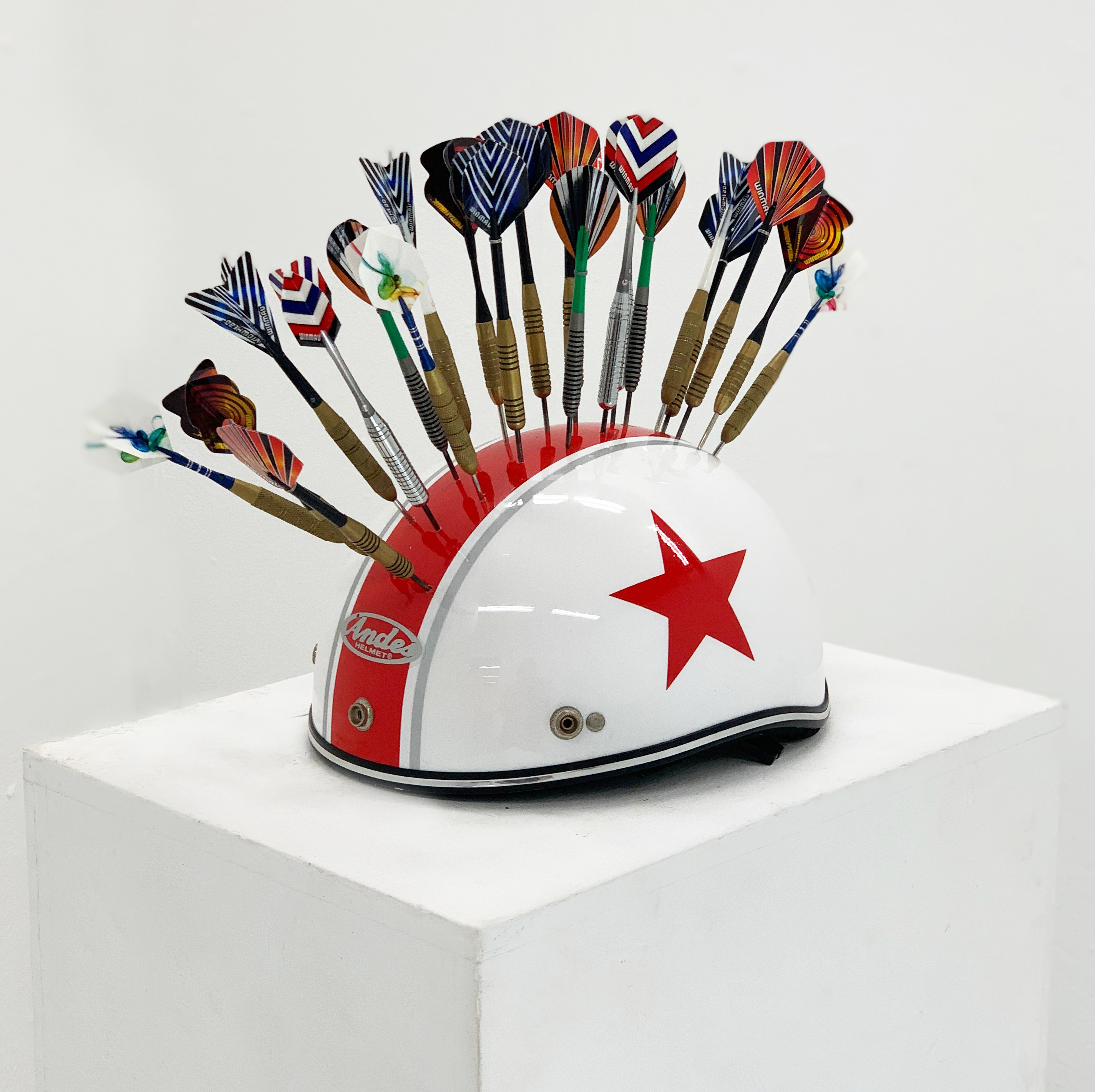 "Untitled" (Helmet and darts.) 2019. - Found objects.